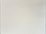 a piece of white paper on a table with a cup of coffee