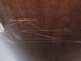 a close up view of a wooden table with a spider web on it