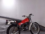 a red and black motorcycle parked in a parking garage