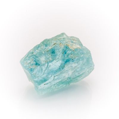 a very large piece of blue colored rock on a white surface