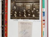 an old photo of a group of people sitting in a room