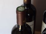 several bottles of wine are lined up on a wooden table