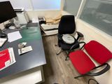 a desk with a chair and a clock on it