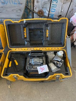 a yellow case with tools in it sitting on the ground