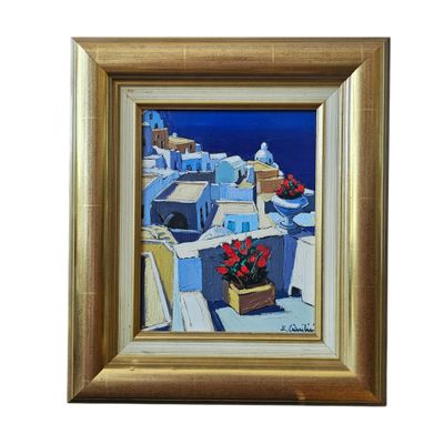 painting of a view of the sea and buildings with red flowers in a gold frame