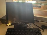 a computer on a desk with a keyboard and mouse