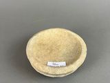 a close up of a bowl on a table with a label on it