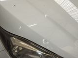 a close up of a car ' s headlight on a tile floor