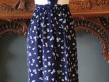 a dress on a mannequin stand in front of a fireplace