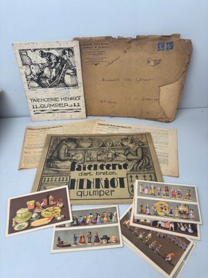an assortment of postcards and postcards are on display on a table