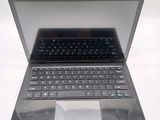 a laptop computer with a keyboard on a white surface