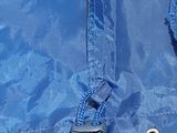 a close up of a blue umbrella with a black handle
