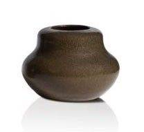 a brown vase that is sitting on a white surface