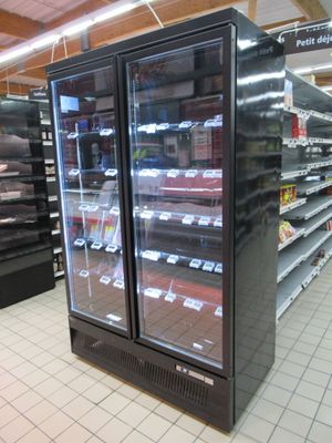 two refrigerators that are sitting in the middle of a store
