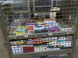a metal cart with a bunch of books inside of it