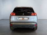 the rear end of a silver suv parked in a white room