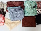many different types of clothes laid out on a table