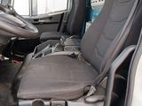 a seat in the back of a truck with a bag in it