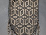 a gray and white bag with fringes hanging from it