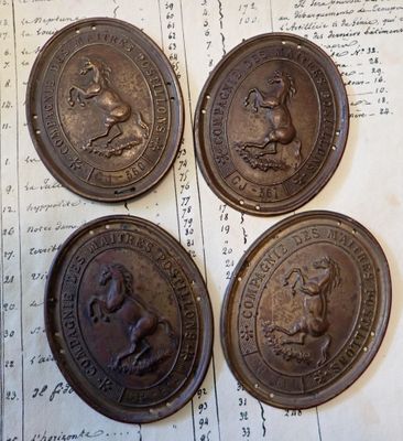 quatre pièces de monnaie anciennes en bronze posées sur un morceau de papier