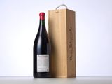 a bottle of wine sitting next to a wooden box