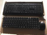 two keyboards and a mouse sitting in a box
