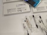 a lot of pens and a cell phone on the table