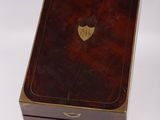 a small wooden box with a brass plate on top of it