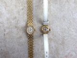 two watches that are sitting next to each other on a table
