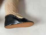 a close up of a person ' s feet wearing a pair of black shoes