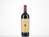 a bottle of red wine sitting on top of a table