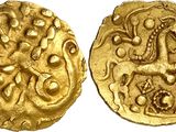 a close up of two gold coins on a white surface