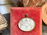 a close up of a red box with a picture of a building on it