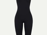 a woman in a black bodysuit with a black top and leggings