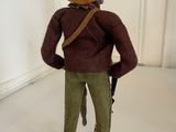 a figurine of a man wearing a hat and holding a gun