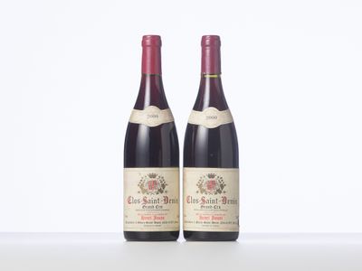 two bottles of red wine sitting on top of a table