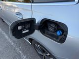 a close up of an electric car plugged in to a charging station