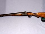 un vieux fusil avec un canon en bois et un étui en cuir