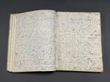 an open book with writing on it sitting on top of a table