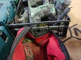 a basket full of tools sitting on the floor