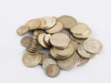 a pile of coins sitting on a white surface