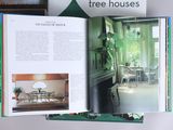a book opened to show a picture of a living room