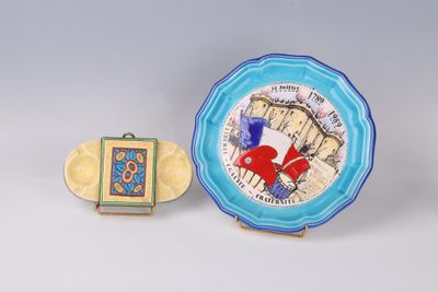two pieces of art nouveau pottery, including a plate with a picture of a red heart and a blue plate with a picture of a red heart