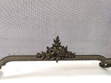 an antique bronze fireplace screen with flowers and leaves on it