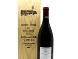a bottle of wine sitting next to a wooden box