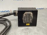 a picture of a black box with a black cord attached to it