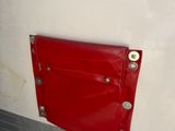 a red door on the side of a white wall