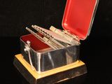 a small metal box with a bunch of tools inside of it