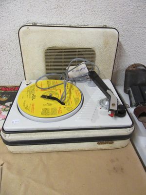 a record player sitting on top of a suitcase