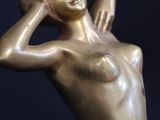statue of a woman holding her head in her hands